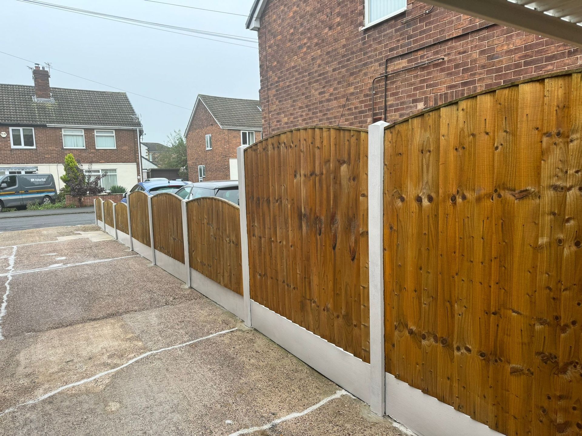 Fencing cleaned and sealed with a semi-transparent honey color, enhancing the wood's natural texture and providing a fresh, protective finish.