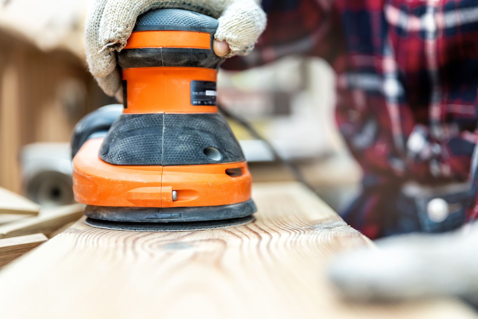 Person sanding timber as part of a timber restoration service, smoothing the surface to restore its natural beauty