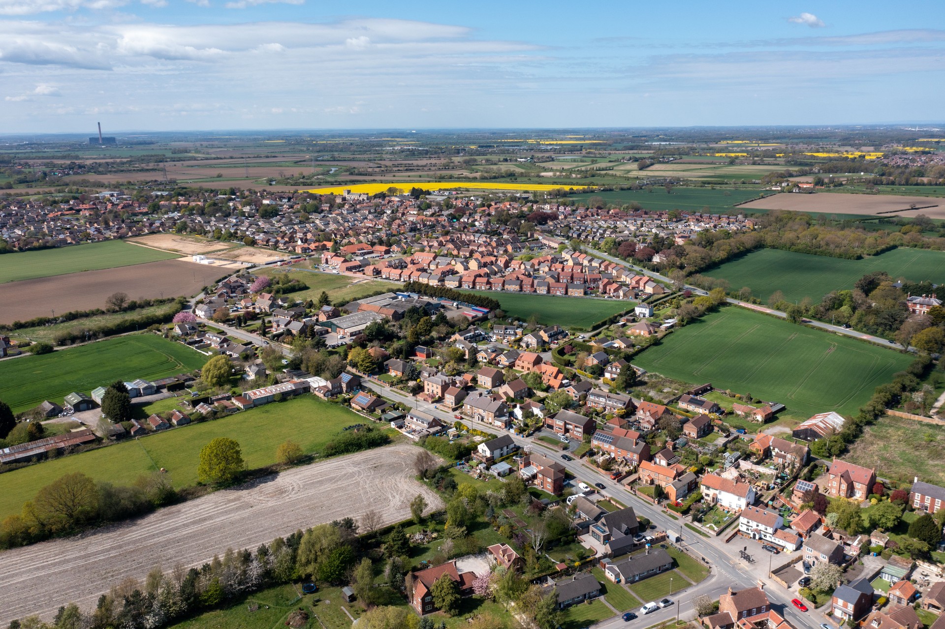 Aerial drone photo of the village of West Cowick in Goole in the East Riding of Yorkshire England showing the streets and houses and homes in the British village in the summer time